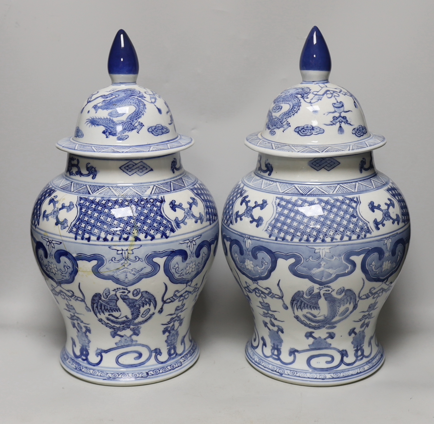 A pair of Chinese blue and white baluster vases and covers, 45cm high